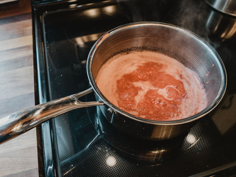Strawberry mixture reducing on electric stovetop